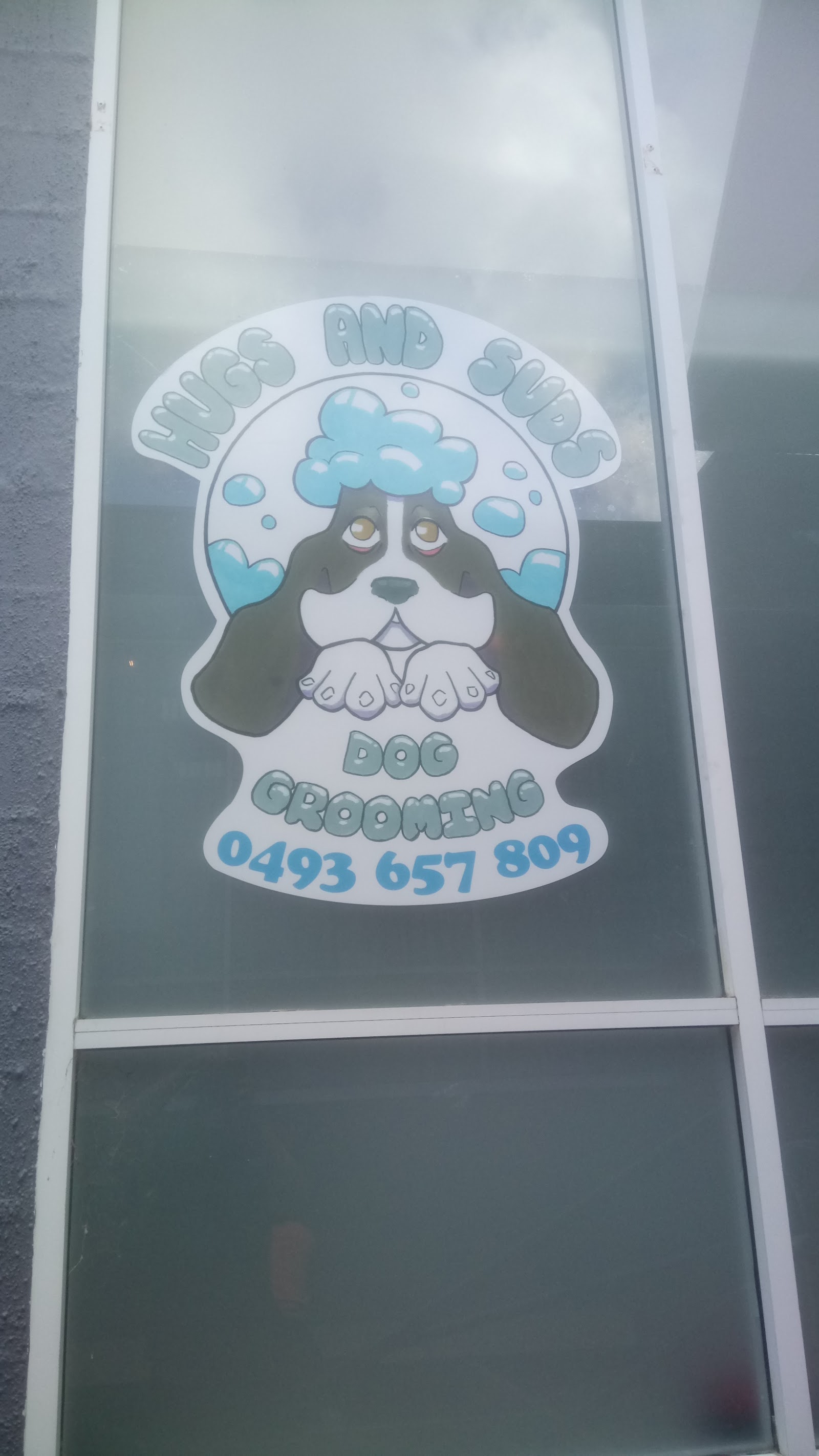 Hugs and Suds Dog Grooming logo